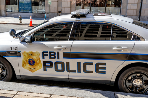 FBI police car parked on city street.