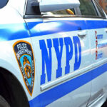 NYPD CRUSHED — Untested Civilians Replace Trained Officers… Close-up of a NYPD police car.