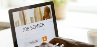 Person using laptop for job search.