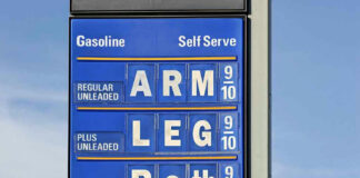 Gasoline price sign with humorous mode of payment.