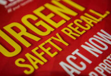 Urgent Safety Recall sign on red background.
