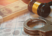 Judge EXPLODES — No More PAROLE! Handcuffs on fingerprint sheet with gavel and cash