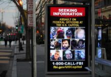 Bus stop display with FBI notice showing multiple suspect photos